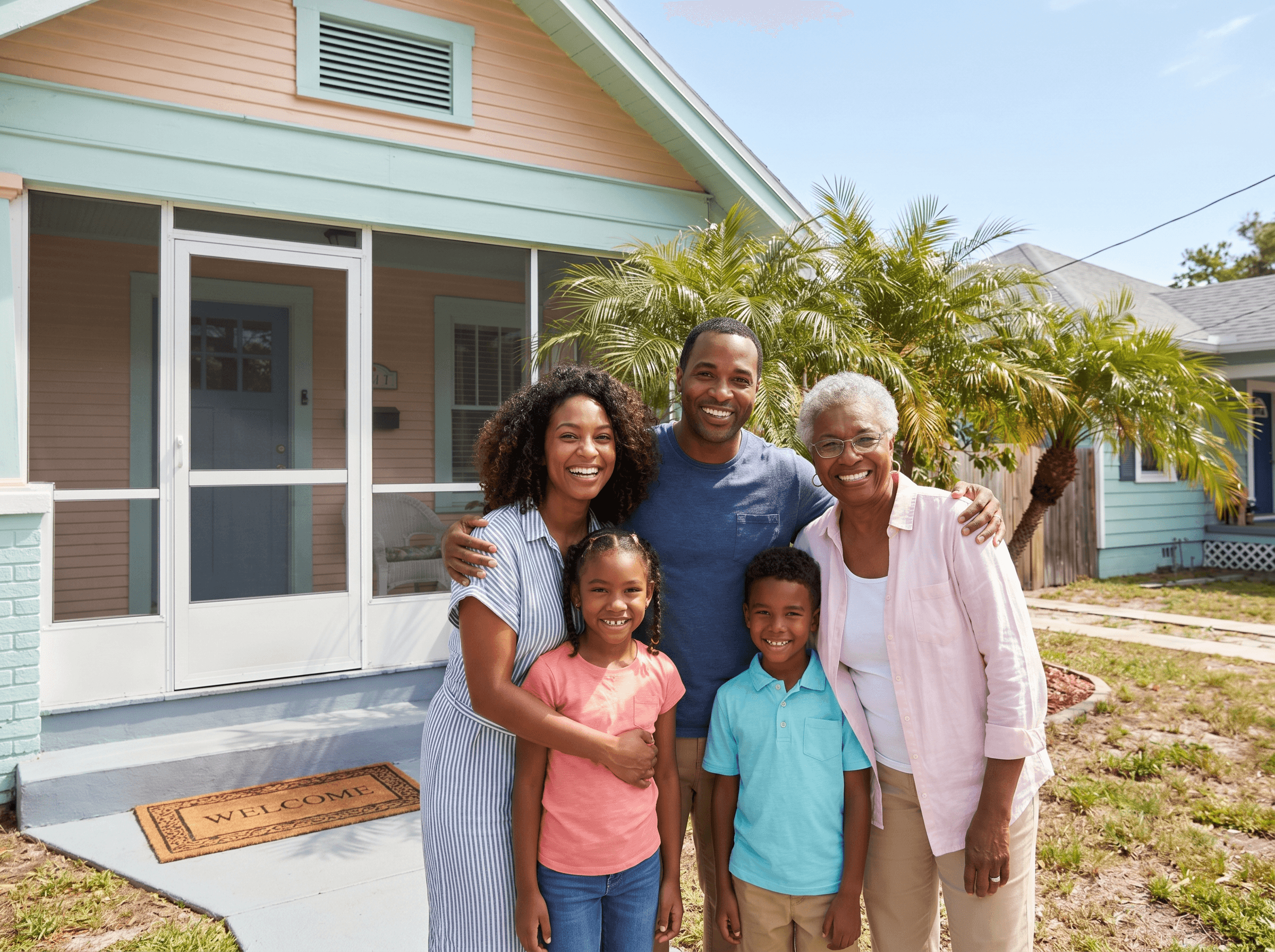 Happy family in front of home